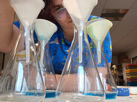 Technician using beakers